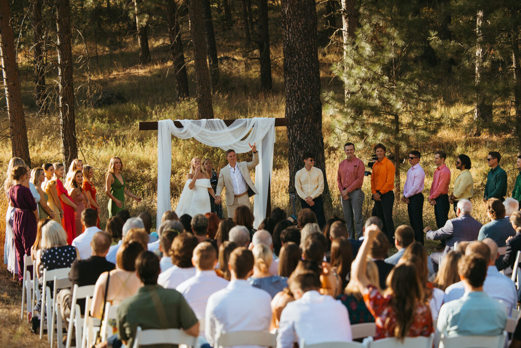 Bride and groom acknowledge their guests in Idaho destination wedding 