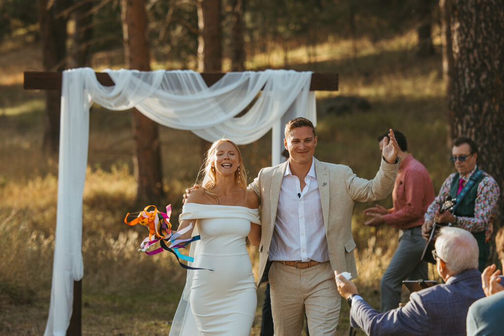 Bride and groom joyfully make their grand exit in Idaho destination wedding