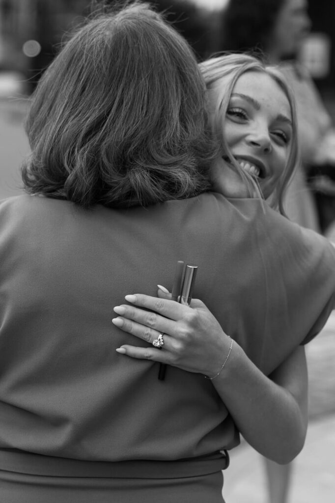 Bride hugs groom's mother in warm and joyful embrace on the day of her courthouse wedding