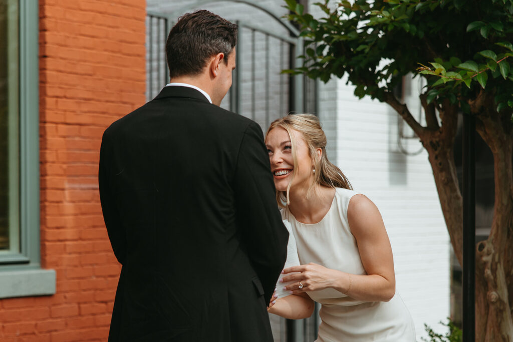 Bride doubles over in laughter as she reads vows to groom