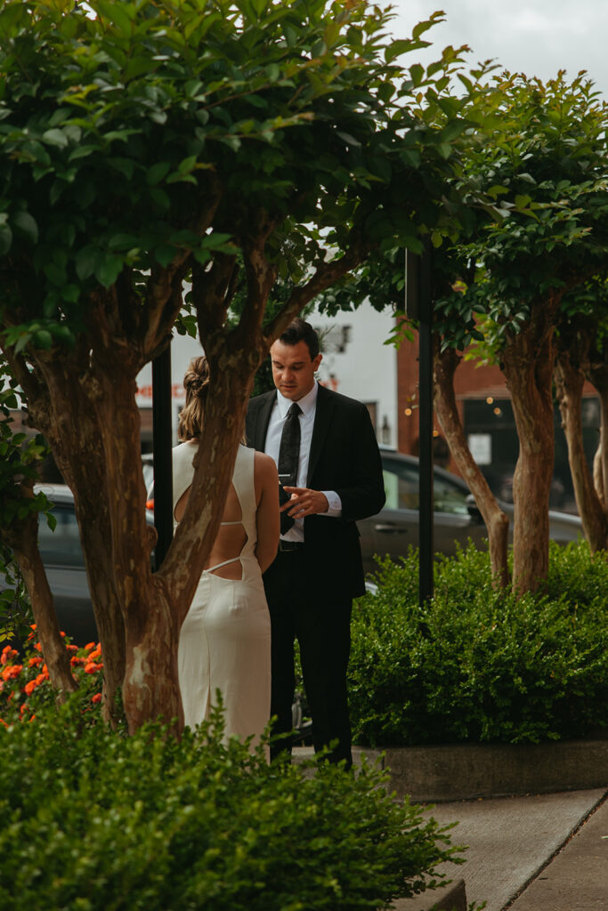 Bride and groom stand under the trees lining Main Street in Springfield, Tennessee as they exchange vows