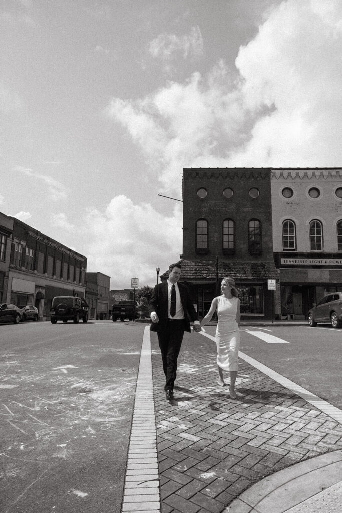 Bride and groom walk up and down Main Street of Springfield, Tennessee hand in hand