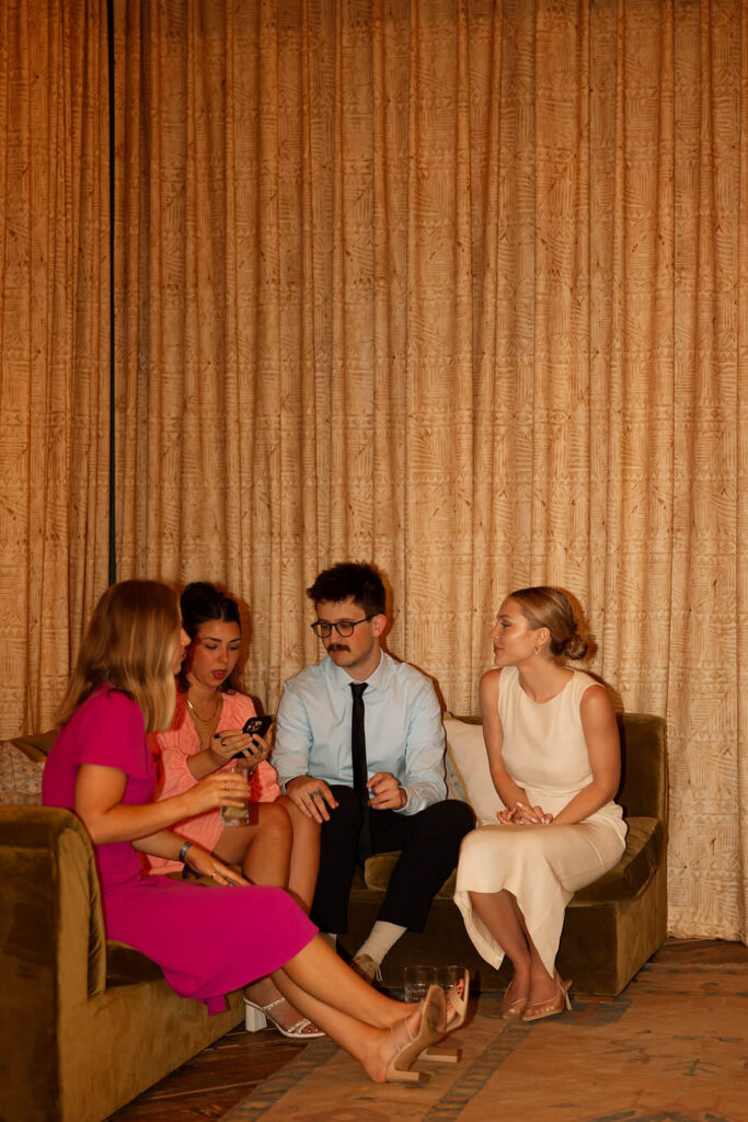 Bride and her friends chat in the corner during courthouse wedding after party