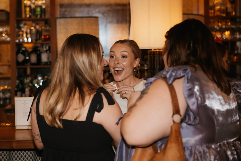 Bride engrossed in animated conversation with her friends