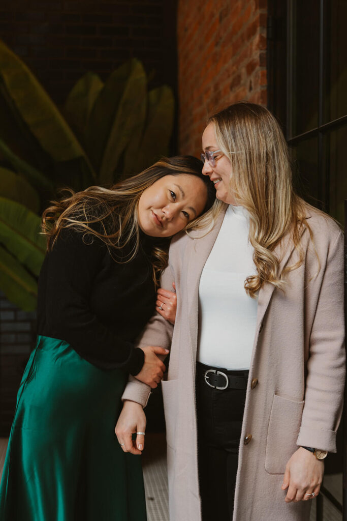 Woman leans head on fiance's shoulder in mini-moon engagement session.