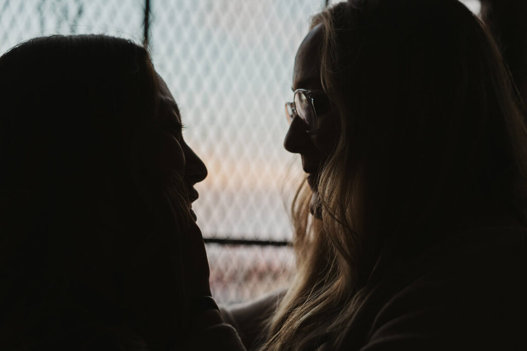 Silhouettes of engaged couple in downtown Nashville warehouse