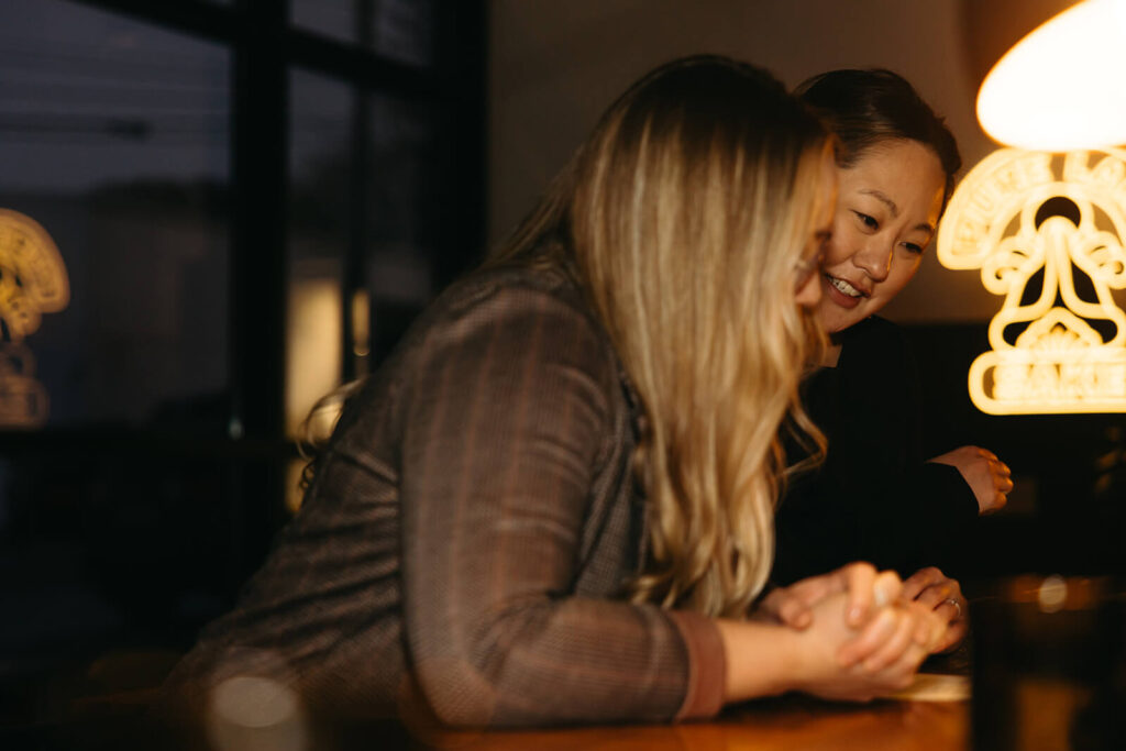 Couple looks at Present Tense menu in Nashville mini-moon engagement session.