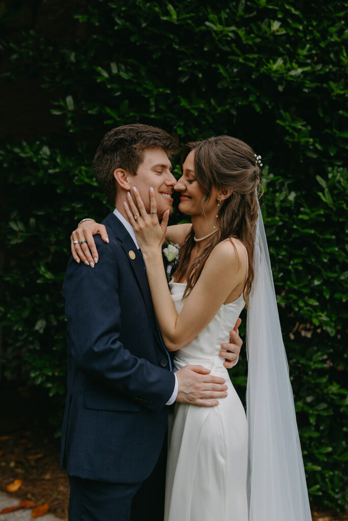 Bride and groom smile as they lean in for a kiss in documentary style wedding photos