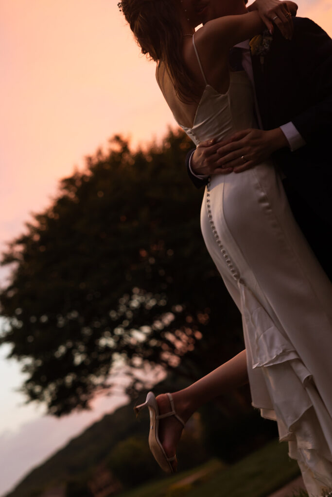 Vibrant Tennessee sunset puts on a show behind bride and groom in documentary style wedding photos