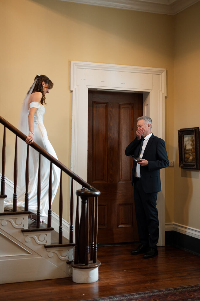 Father of the bride has emotional response as he sees his daughter on her wedding day