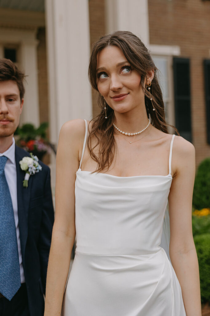 Bride and groom pose for the camera in documentary style wedding photos