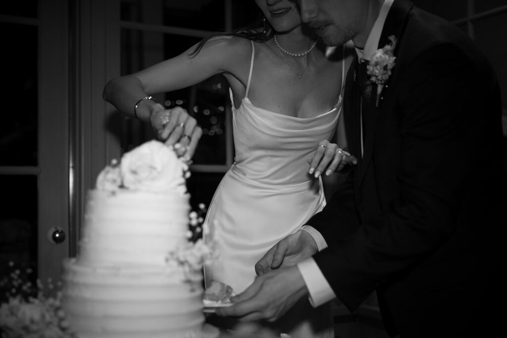 Documentary style wedding photos of bride and groom cutting their cake