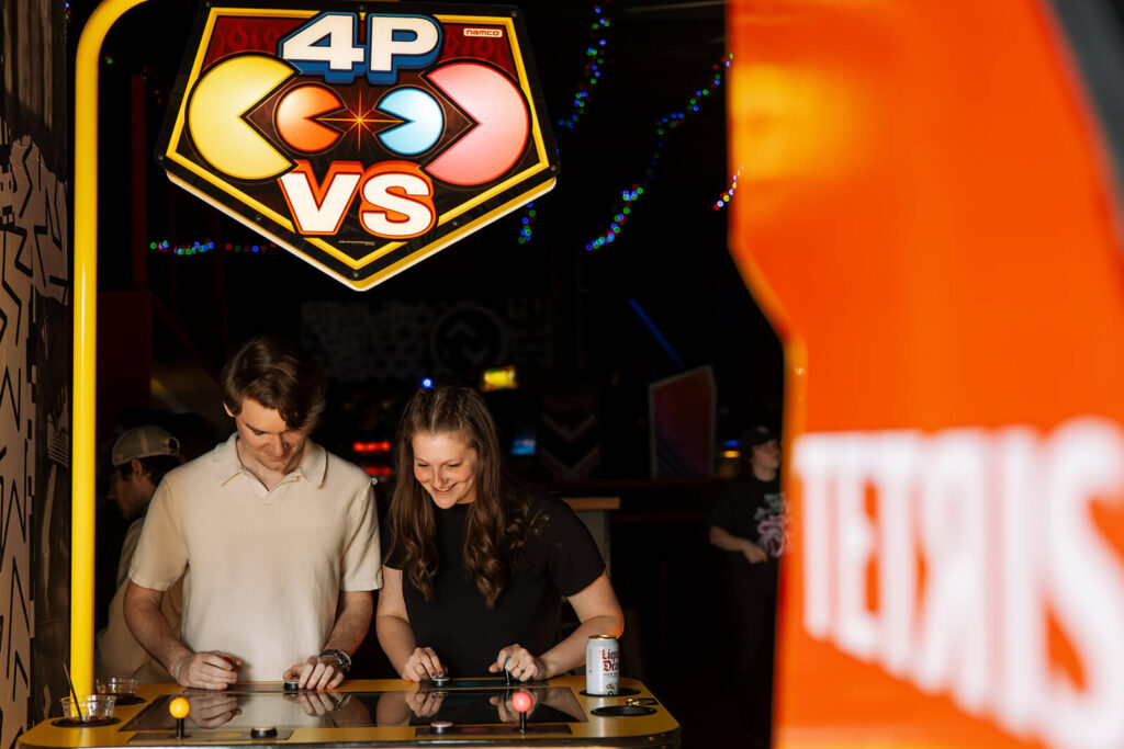 Engagement photographer captures couples playing PacMan at Up Down arcade bar in Nashville, Tennessee