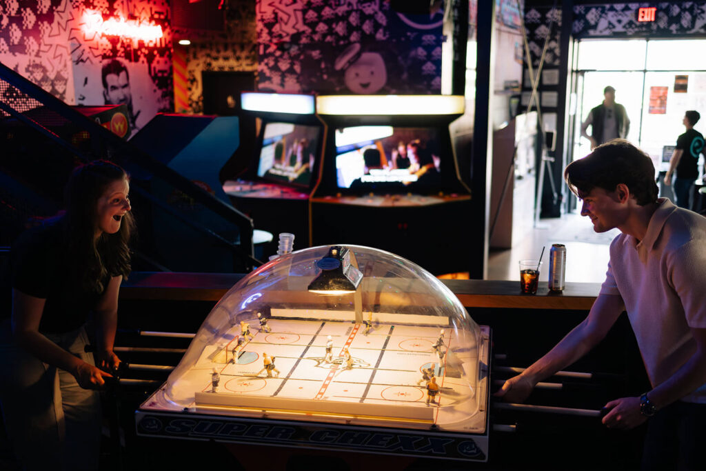 Engaged couple plays foosball at Nashville arcade bar