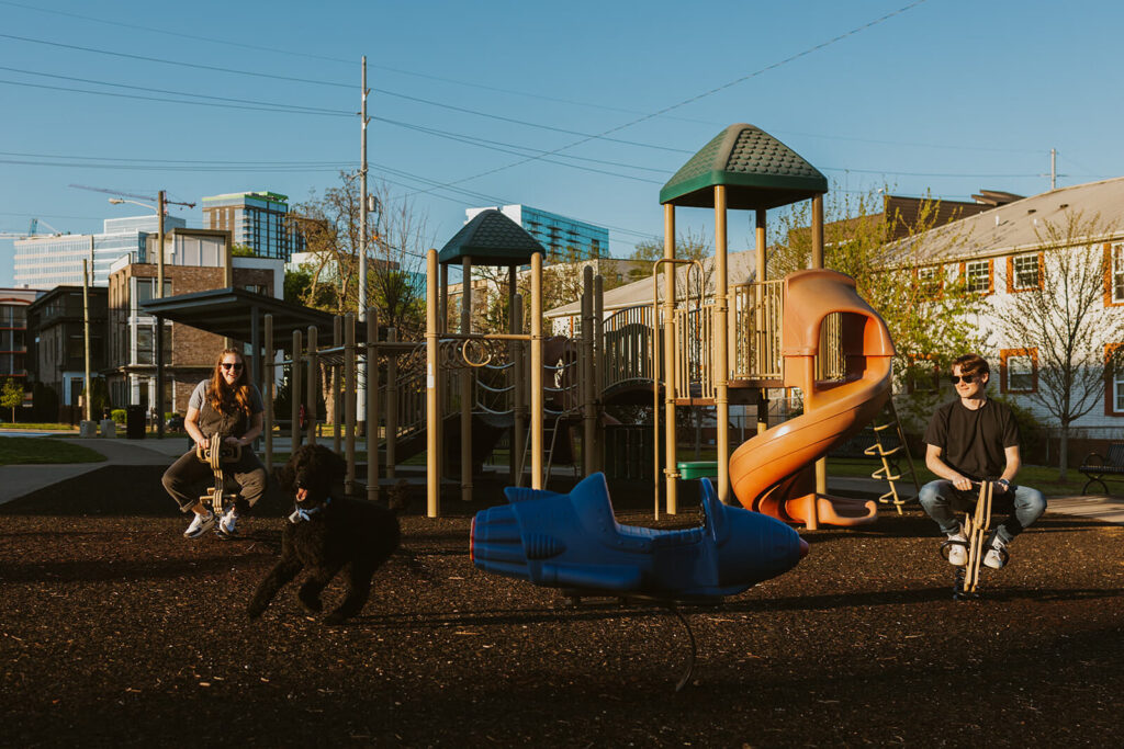 Engaged couple plays on the playground