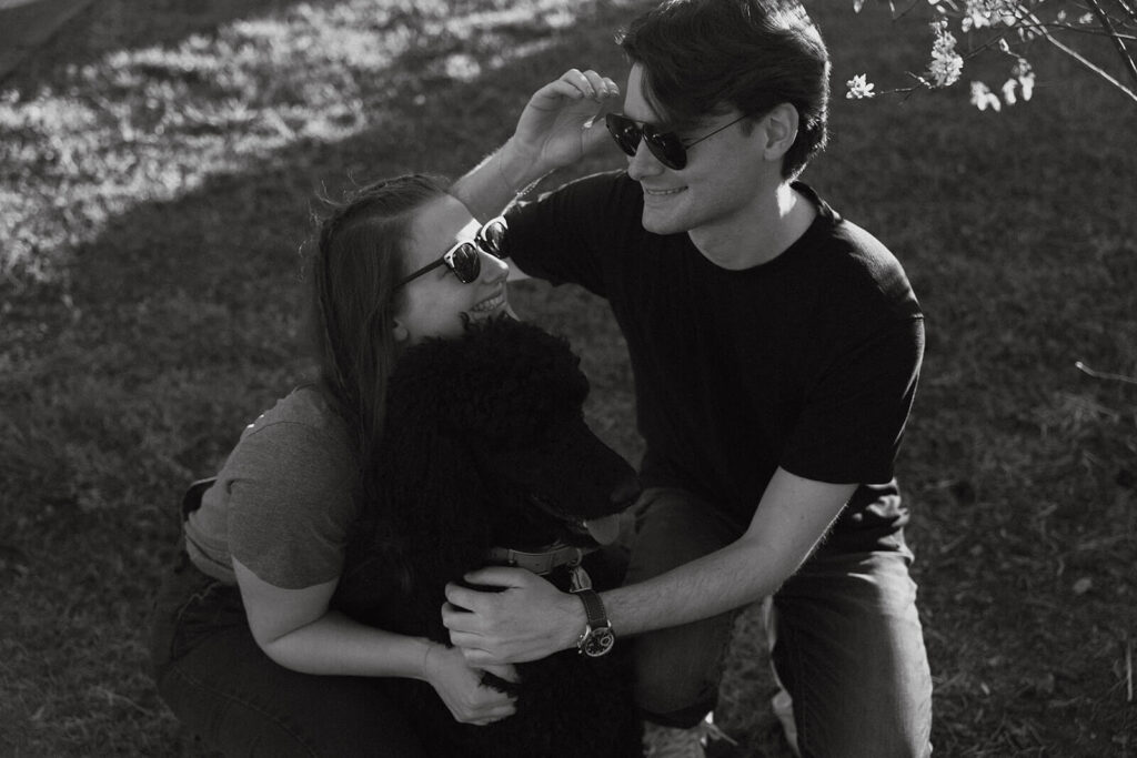 Engaged couple poses with their poodle at Nashville park