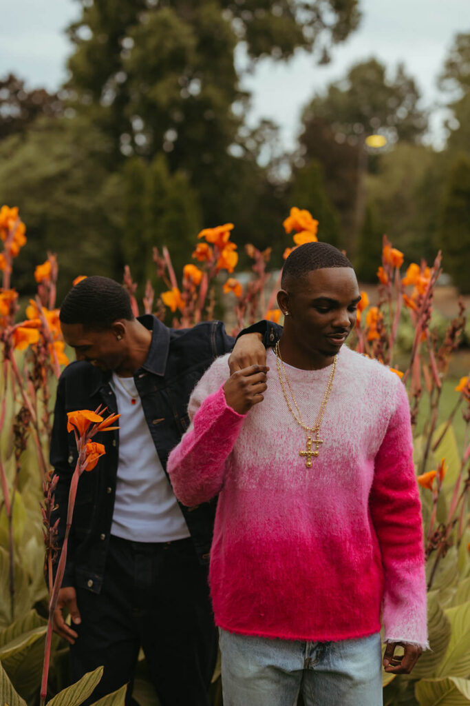 Couple poses in front of orange flowers in Nashville proposal