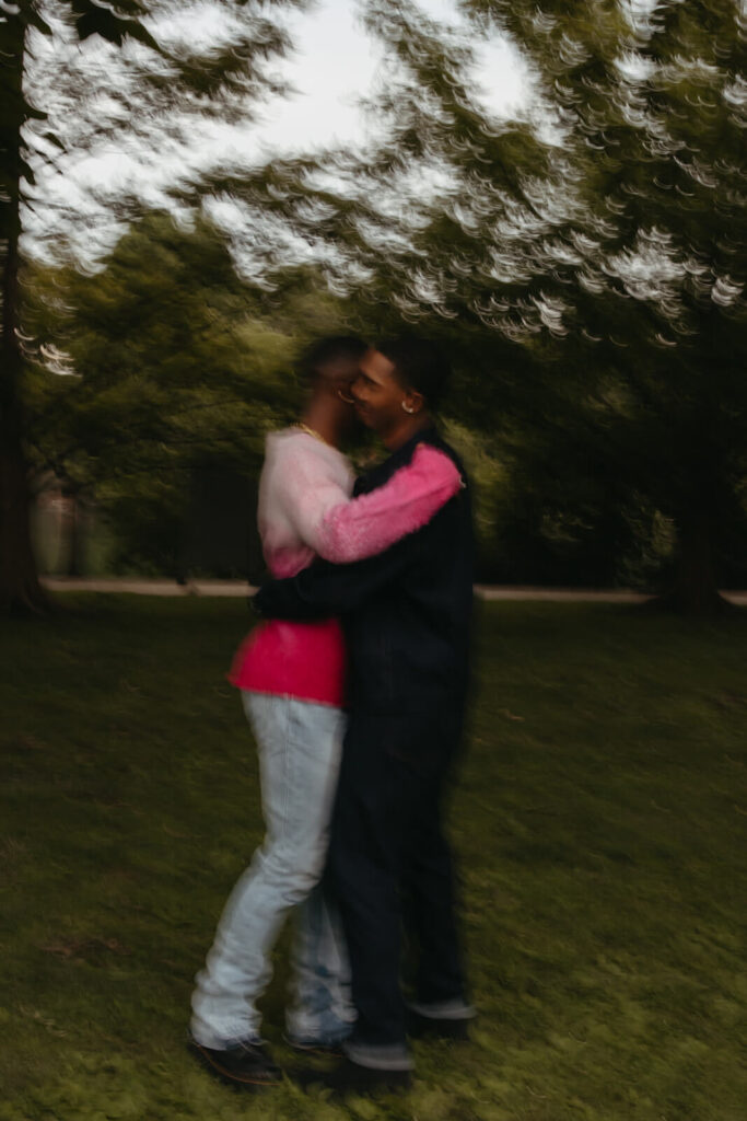 Couple hugs under the shade of trees at the Parthenon in Nashville