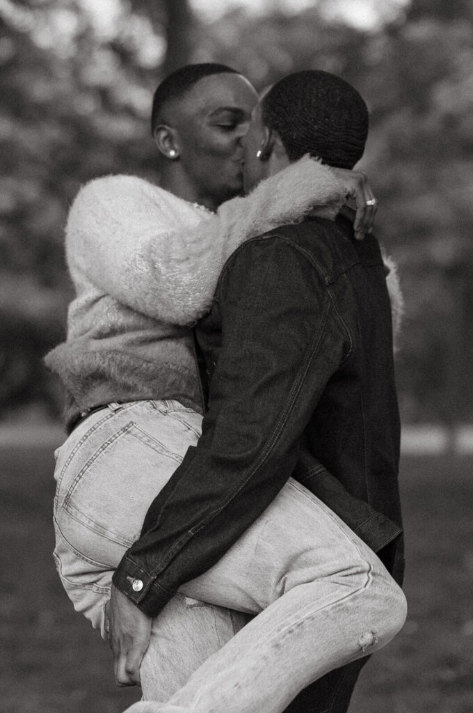 Couple kisses in playful photoshoot