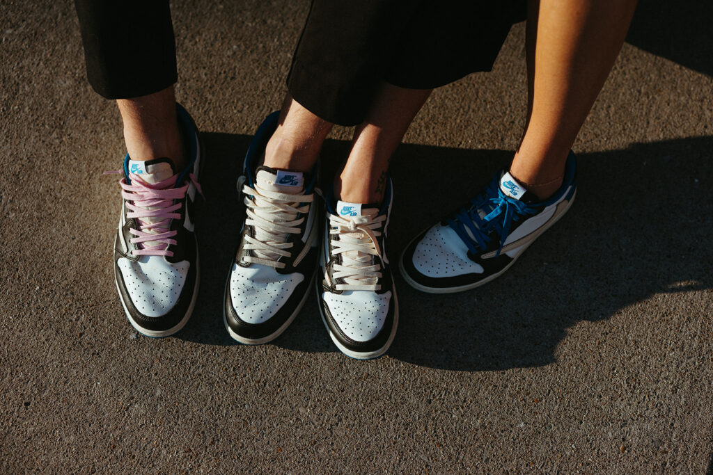 Engaged couple poses with their Nike sneakers 