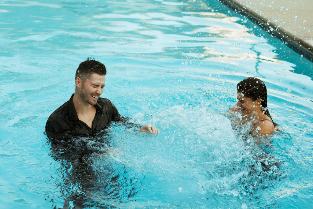 Engaged couple splashes each other in Nashville engagement photoshoot