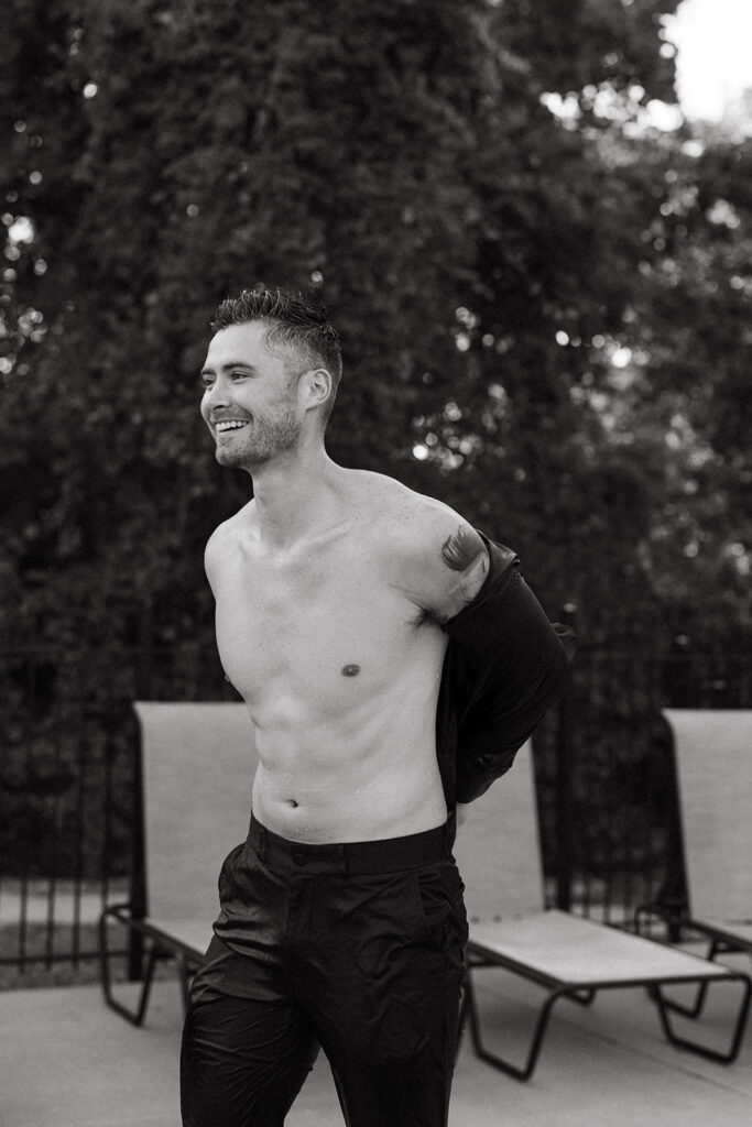 Man smiles while he puts his shirt back on after Nashville photoshoot