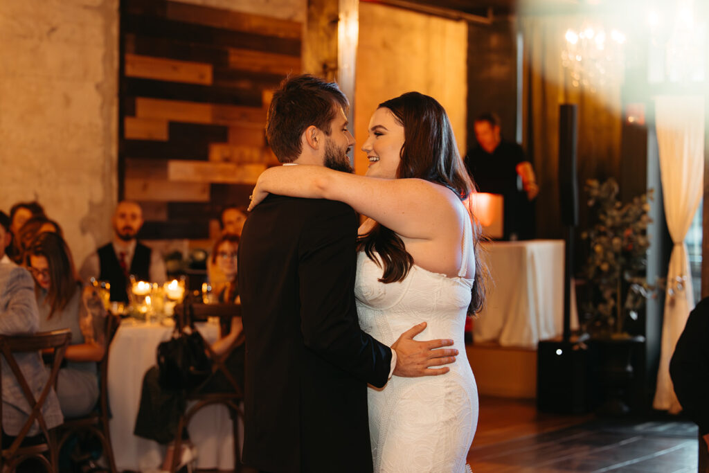 Bride and groom have their first dance under the warm ambience of Emerald Union in Tennessee