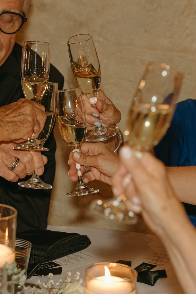 Wedding guests clink glasses of champagne