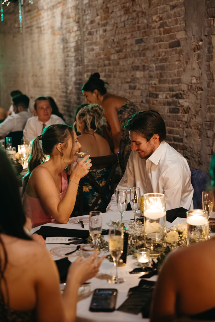 Wedding guests share a laugh during cocktail hour at wedding venue in Tennessee