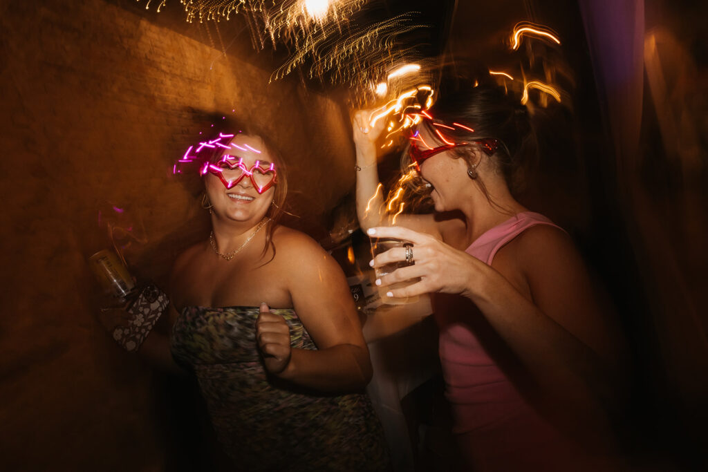 Wedding guests dance under the warm lighting of wedding venue in Tennessee