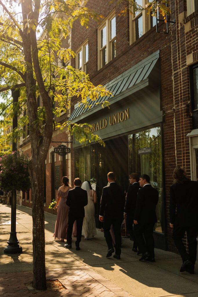 Wedding party and guests walk into summer wedding venue in Tennessee