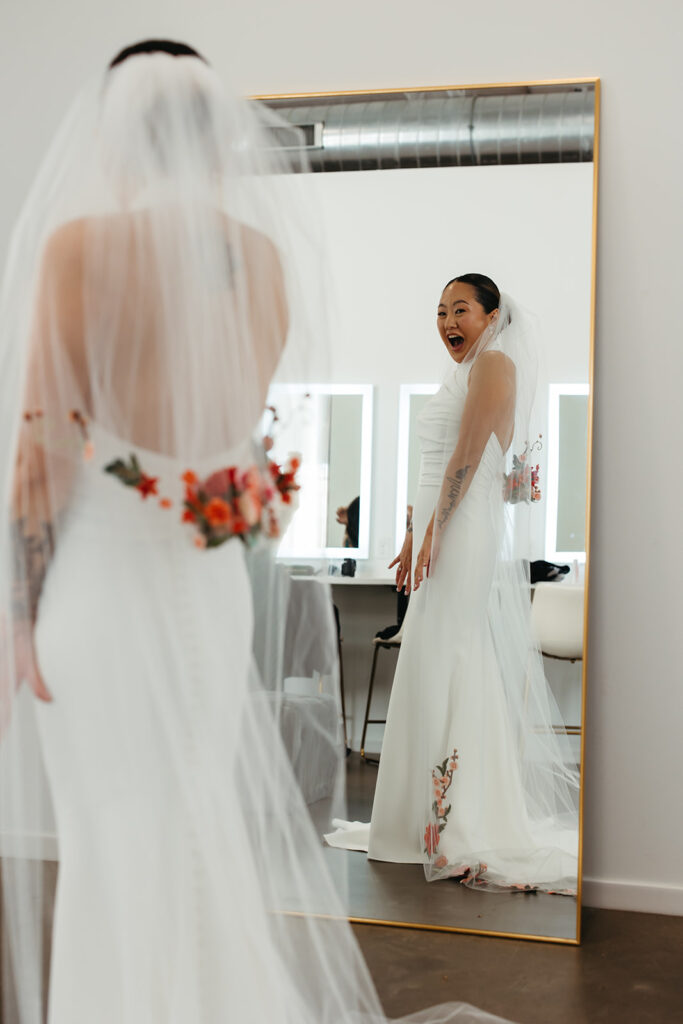 Bride exclaims in the mirror at her appearance