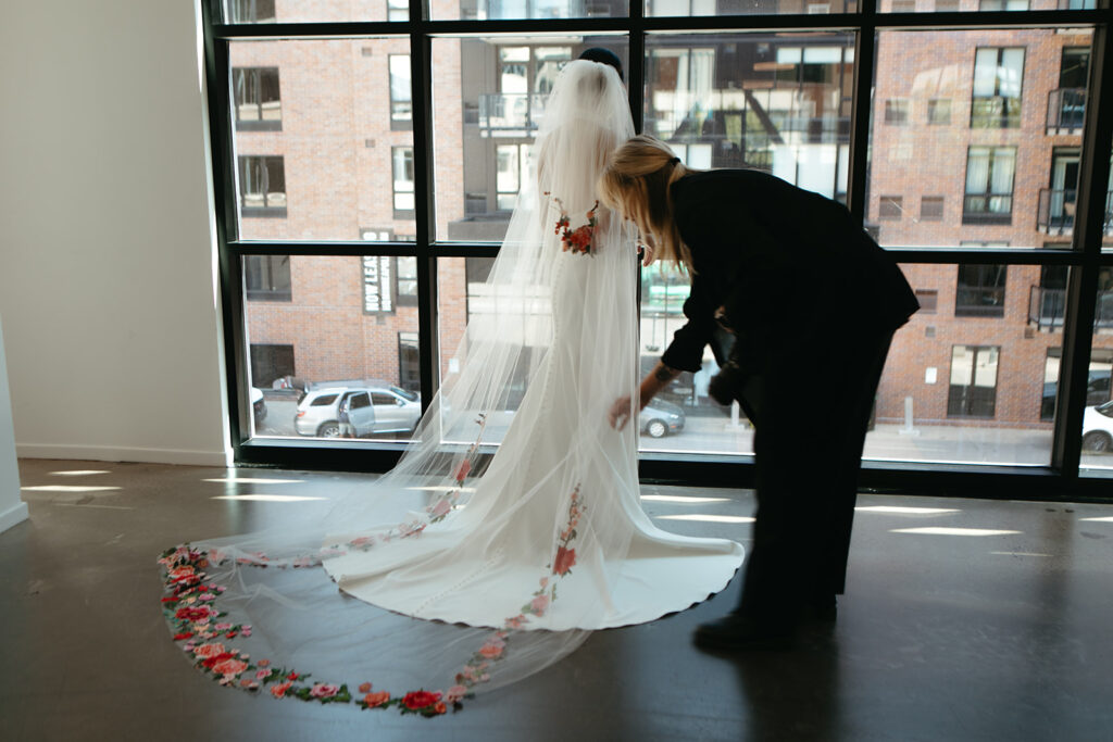 Traveling wedding photographer fixes bride's veil in queer wedding filled with Minneapolis wedding vendors