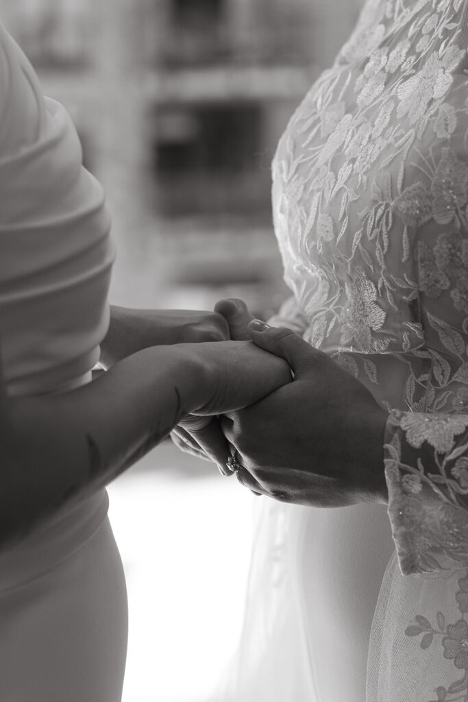 Brides hold hands during first look