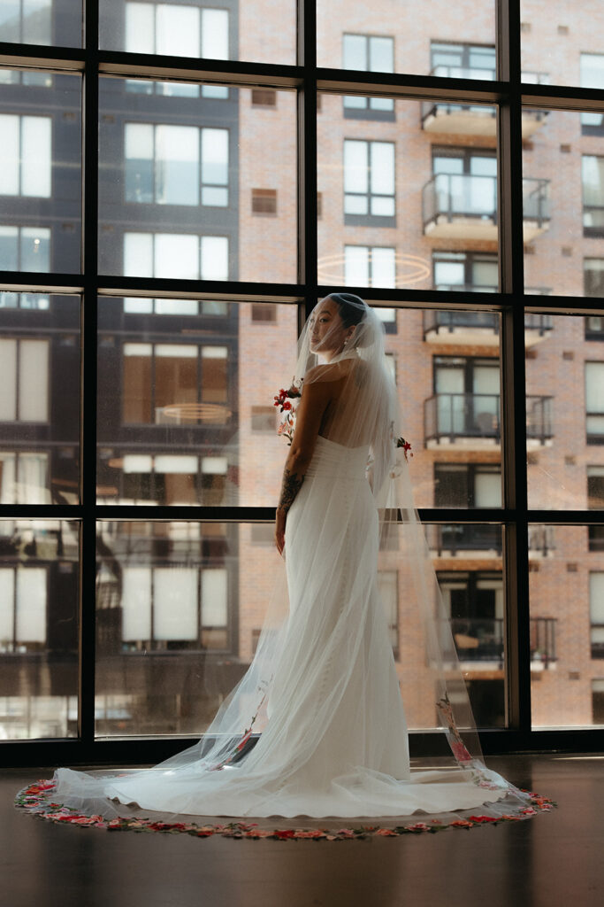 Elegant bride stands in front of cityscape view