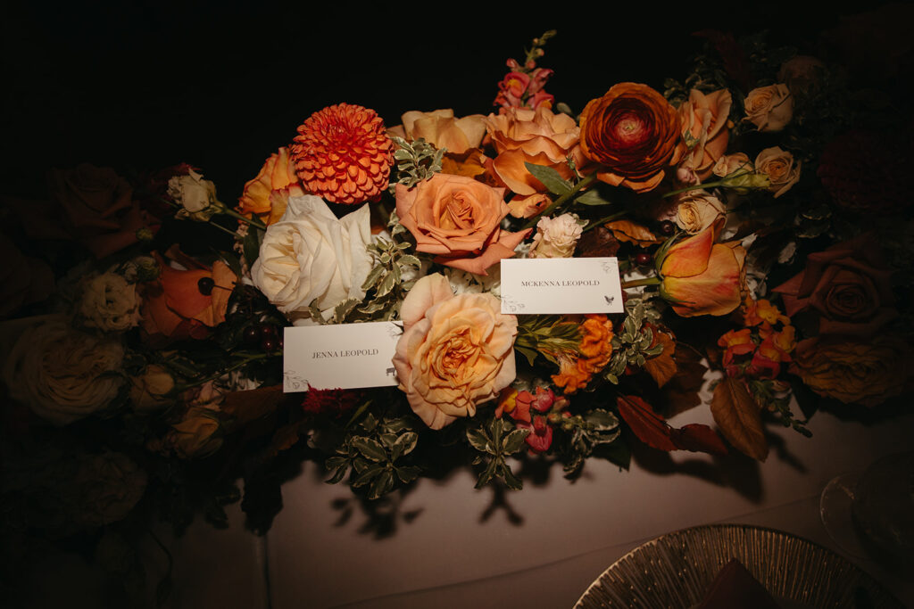 Autumnal floral arrangement on head table of wedding