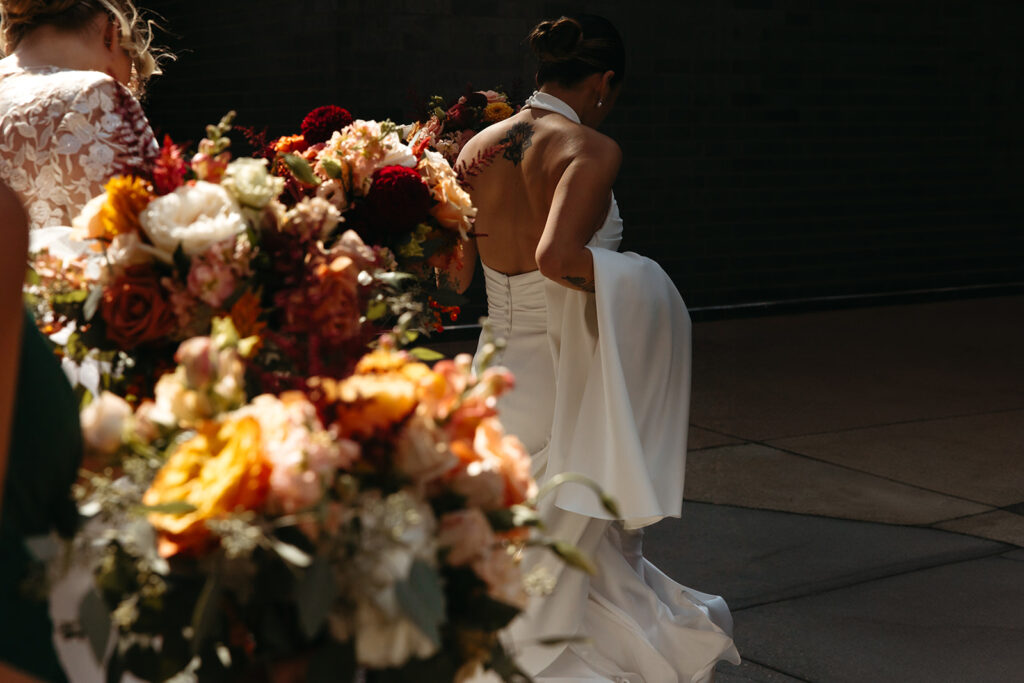 Bride walks with train in hand through streets of Minneapolis