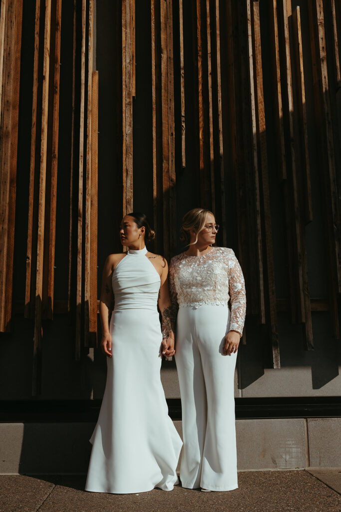 Brides pose outside Minneapolis wedding vendors venue