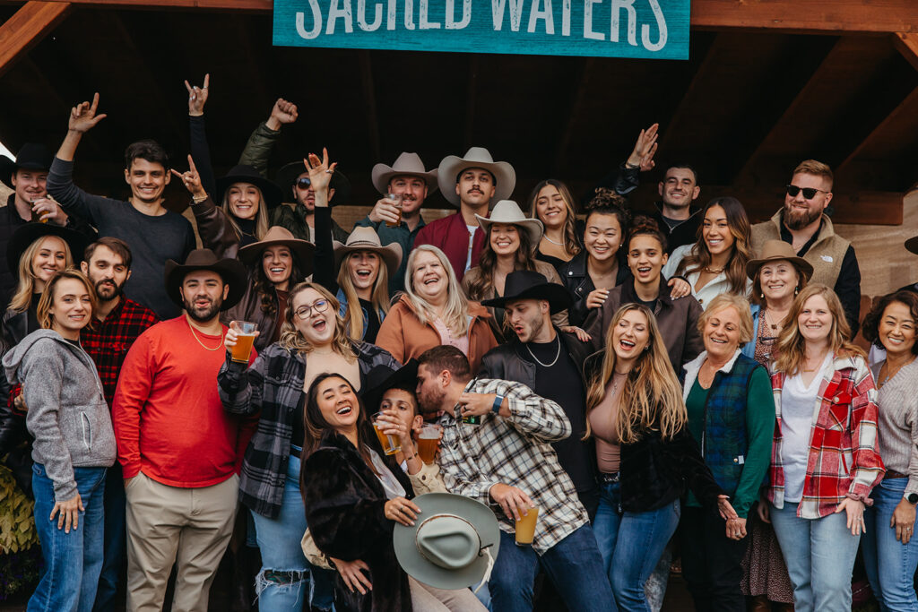 Friends and engaged couple celebrate Yellowstone wedding.