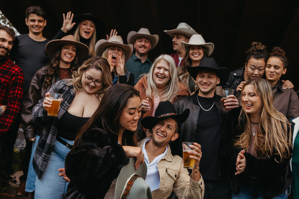 Bride and groom and guests celebrate welcome dinner for their Yellowstone wedding.