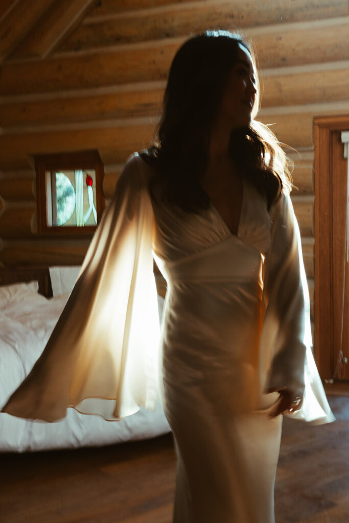 Bride dances in the natural light in cabin at ROAM Beyond.