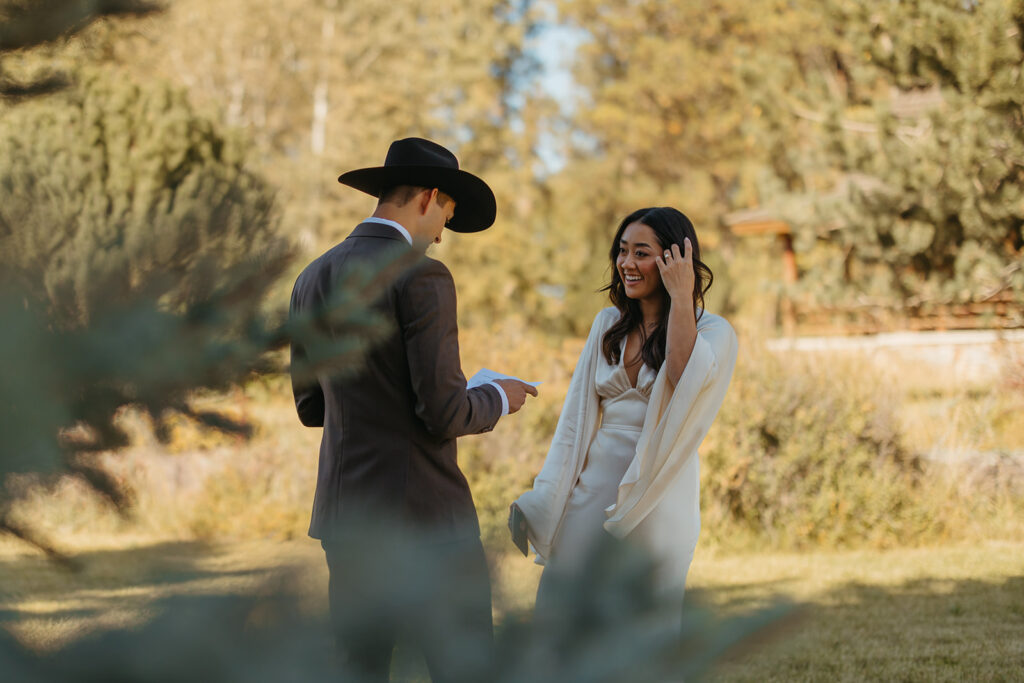 Bride and groom read their vows to each other in Glacier National Park for Yellowstone wedding in Montana.