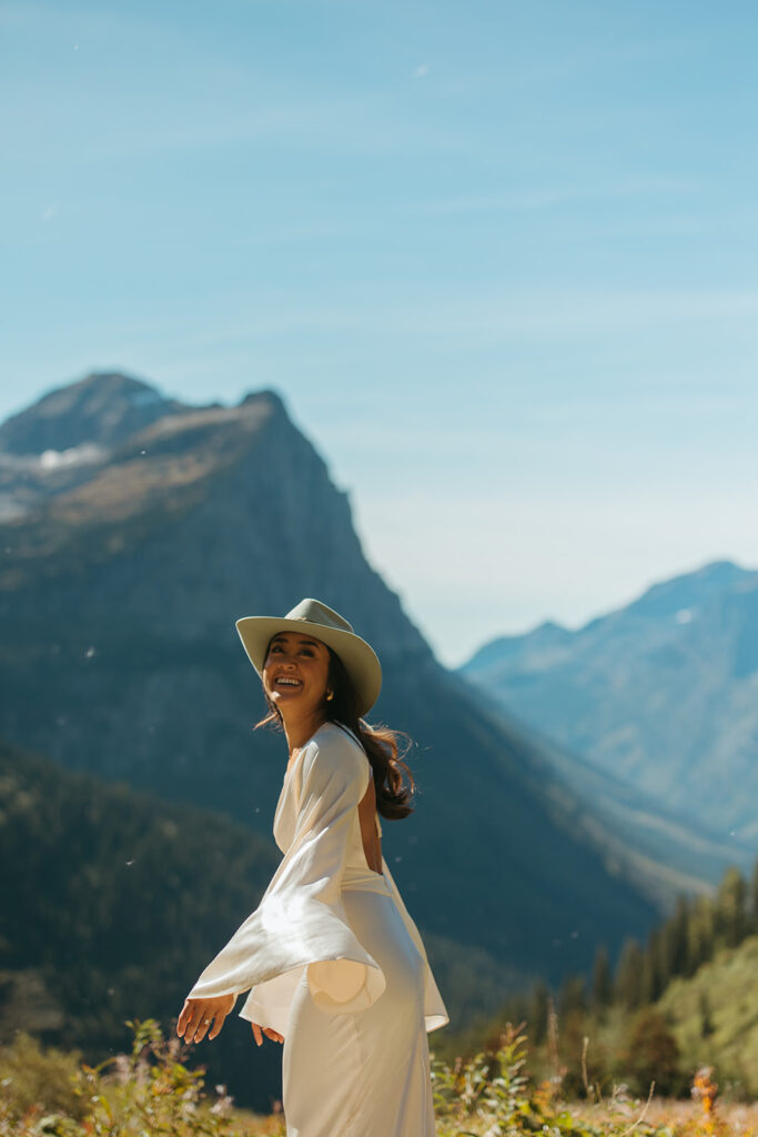 Bride smiles over her shoulder at groom.