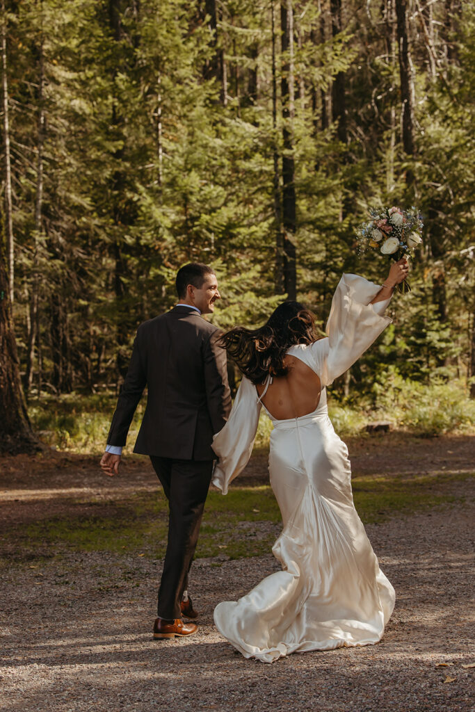 Bride throws her hands in the air after officially becoming a wife in Yellowstone wedding.