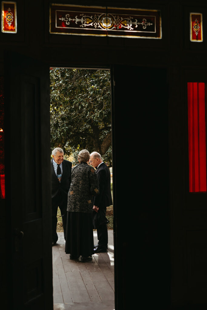 Wedding guests gather in the doorway of historic wedding venue in Nashville