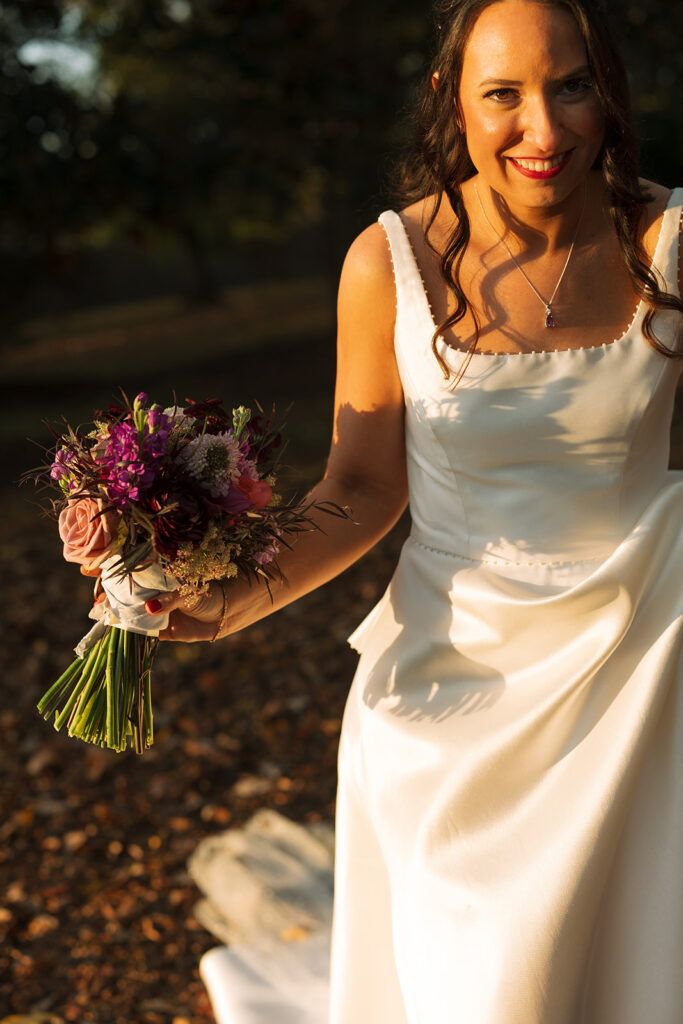 Bride grins at groom as she makes her way towards him