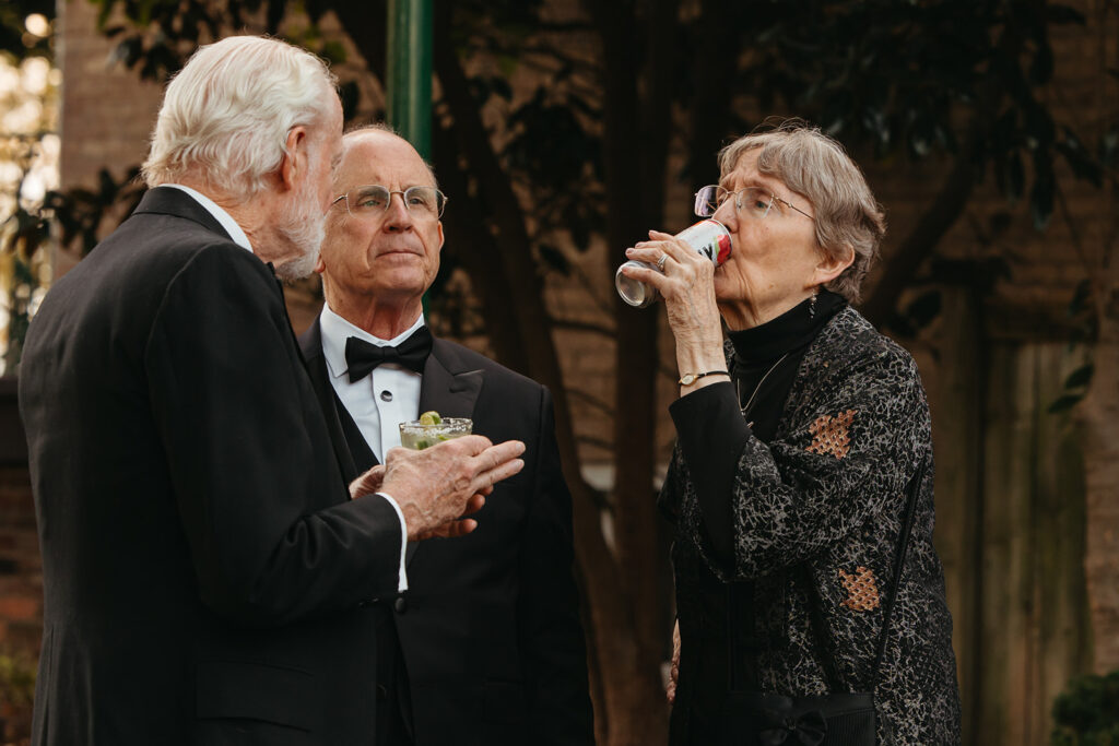 Woman sips from a seltzer while listening to a conversation