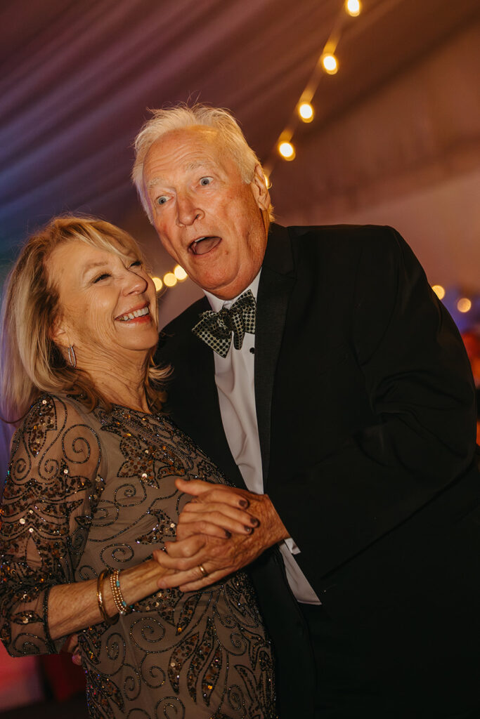 Wedding guests dance together