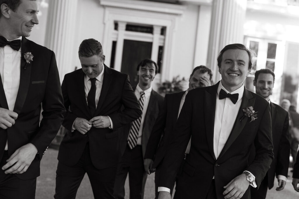 Groom and his friends walk our of historic wedding venue in Nashville