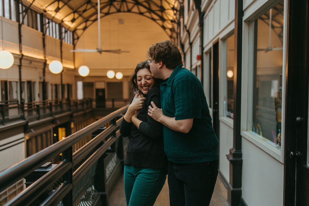 Engaged couple embraces in The Arcade downtown Nashville